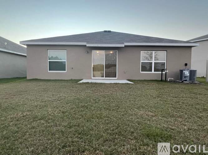 A house with a lawn in front of it is available for rent.
