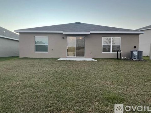 A house with a lawn in front of it is available for rent.