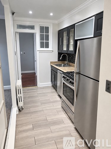 A kitchen with a stainless steel refrigerator and oven.