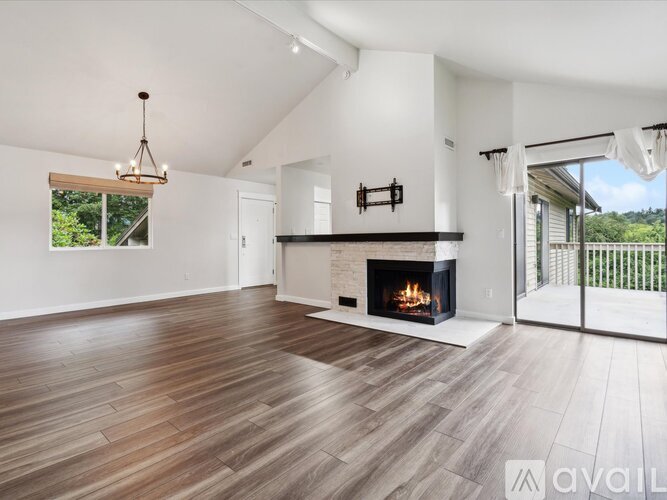 A modern living room with a fireplace and wooden flooring.