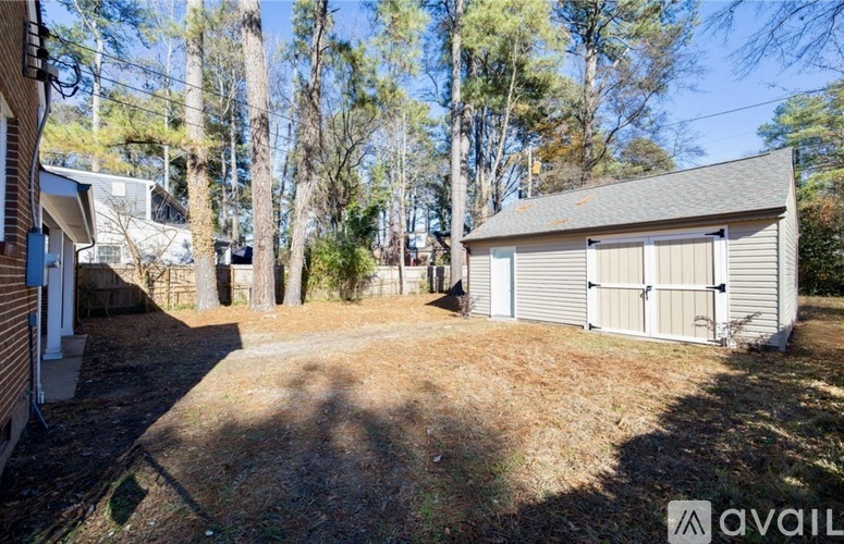 A backyard with a shed and trees.