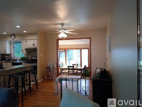 A living room with a kitchen in the background.