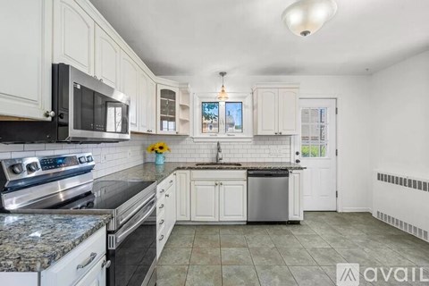 A kitchen with granite countertops and stainless steel appliances.