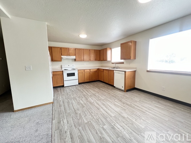 A kitchen with wooden cabinets and a white oven.