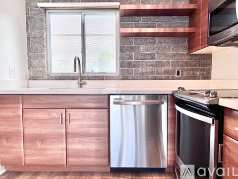 A kitchen with a stainless steel dishwasher and oven.