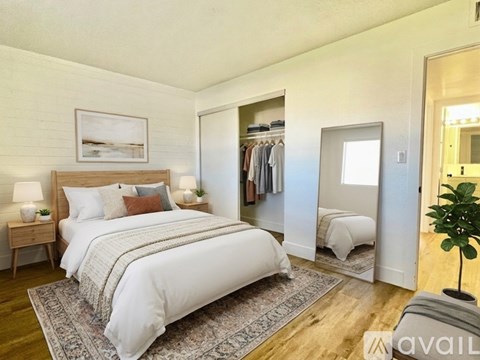 A bedroom with a large bed and a wardrobe.