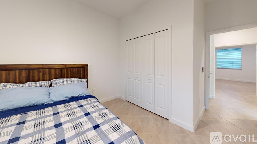 A bedroom with a bed and a wardrobe.