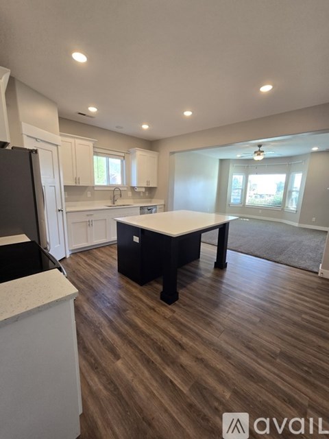 A kitchen with a table and chairs in the middle of the room.