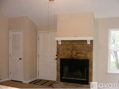 A room with a fireplace and a window.