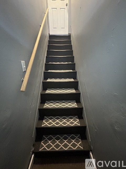 A staircase with a diamond patterned tread.