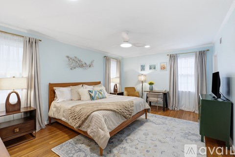 A bedroom with a large bed and a television.