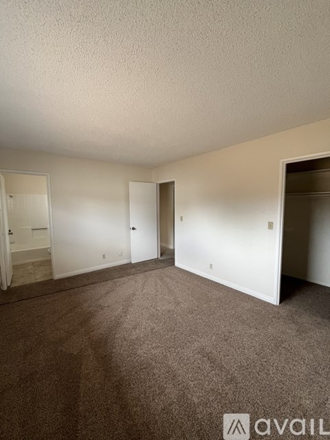 A room with carpeted floor and white walls.