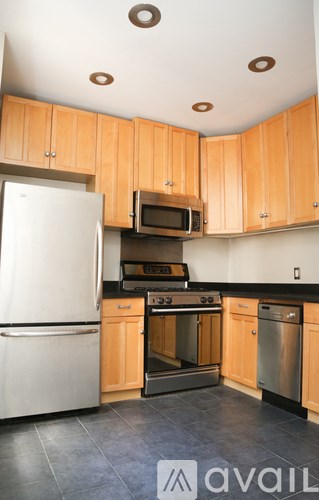 A kitchen with wooden cabinets and a white refrigerator.