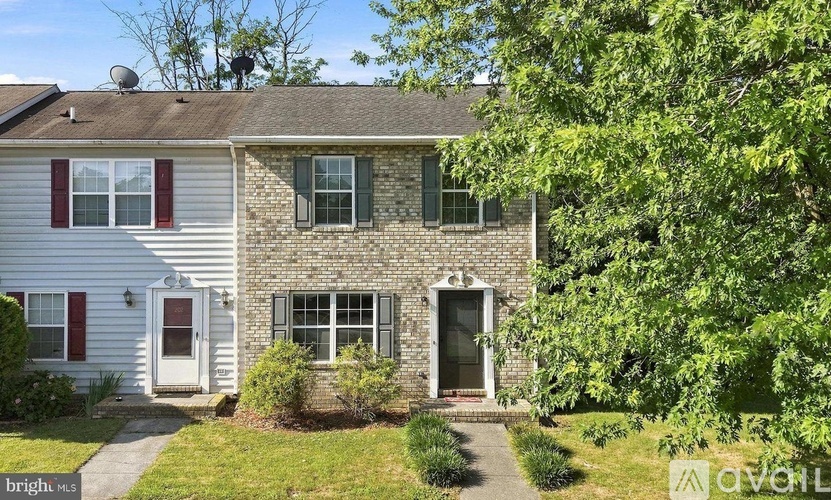 A house with a red door and a window with a green frame.