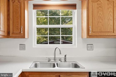 A kitchen with a window over the sink.