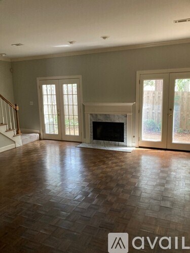 A living room with a fireplace and a tiled floor.