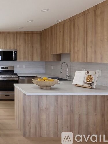 A kitchen with wooden cabinets and a white countertop.