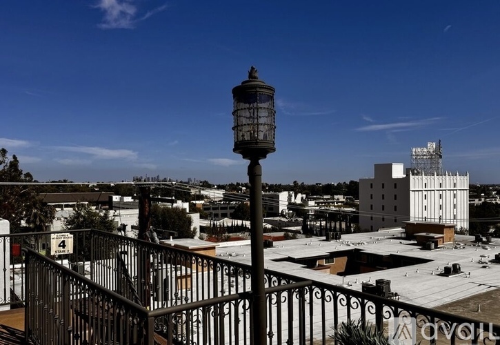 A black lamp post stands in front of a white building.