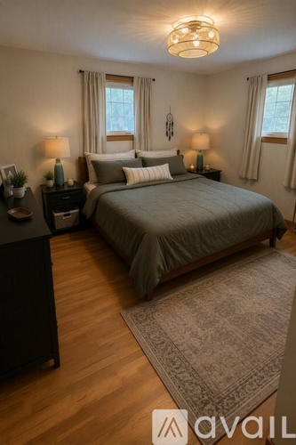 A bedroom with a large bed and two lamps on either side of the bed.