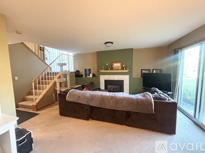 A living room with a fireplace and a couch.