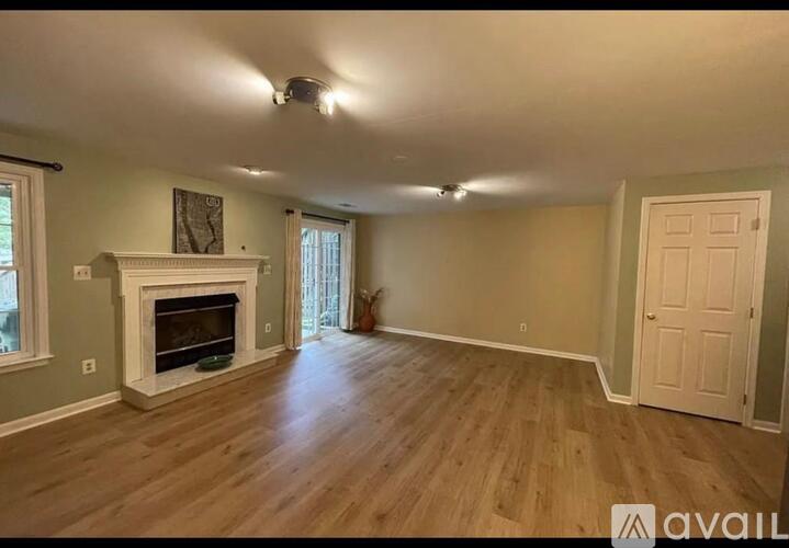 A room with a fireplace and wooden floors.