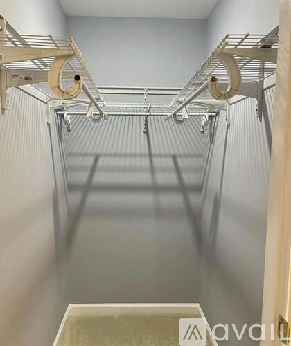 A walk-in closet with shelves and hooks.