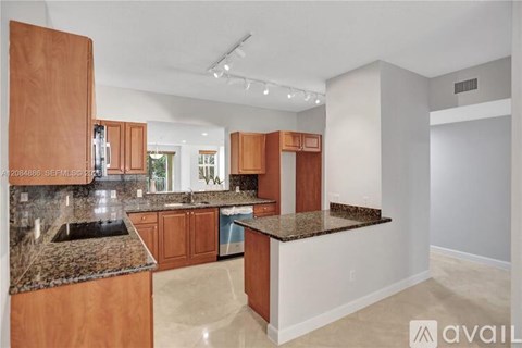 A kitchen with wooden cabinets and granite countertops.