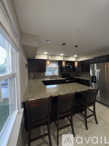 A kitchen with granite countertops and stainless steel appliances.