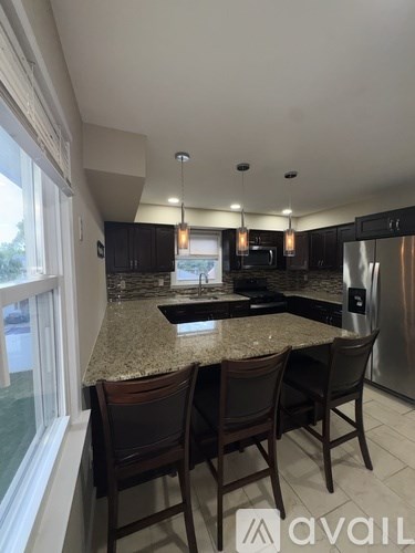 A kitchen with granite countertops and stainless steel appliances.