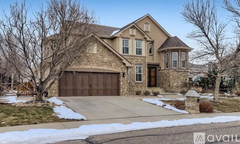 A large house with a stone facade and a brown garage door.