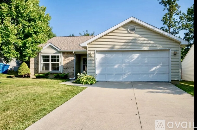 A house with a white garage door is for sale.