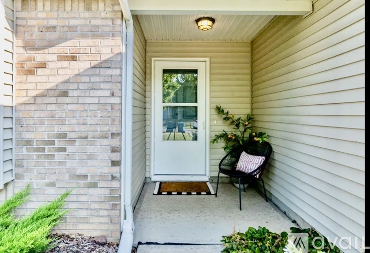 A white door is on the left and a black chair is on the right.