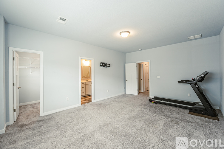 A spacious room with a treadmill and a sign that says "available".