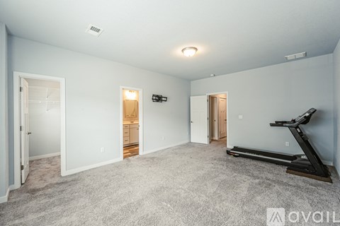 A spacious room with a treadmill and a sign that says "available".