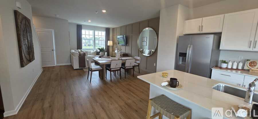 A kitchen with a dining table and chairs in the middle of the room.