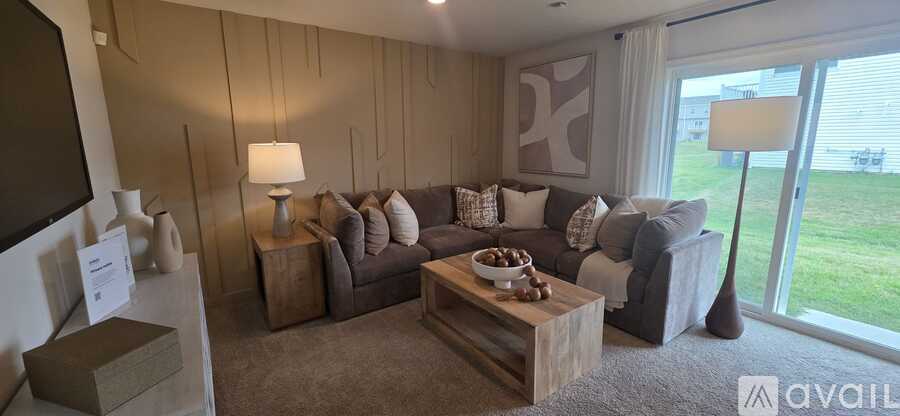 A living room with a grey couch and a wooden coffee table.