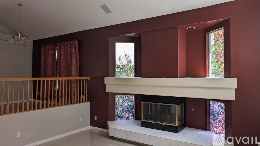 A living room with a fireplace and a balcony.