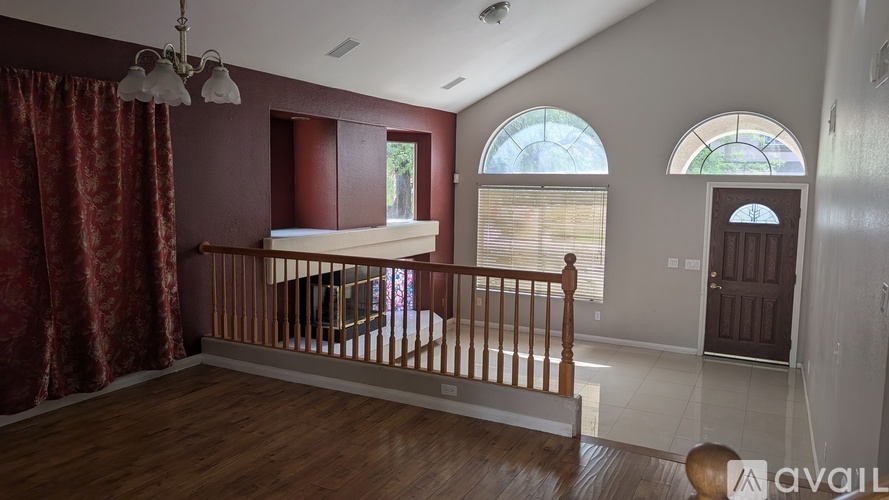 A room with a balcony and a window with blinds.