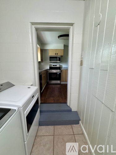 A kitchen with a white oven and a white fridge.