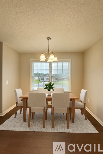 A dining room with a table set for six.