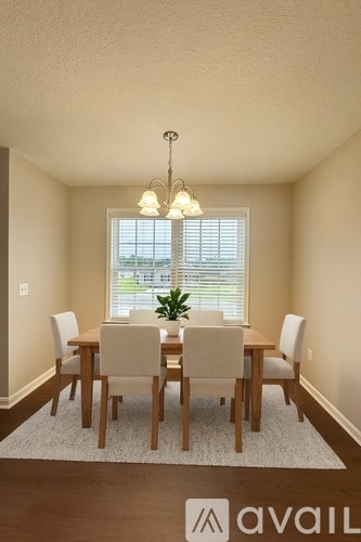 A dining room with a table set for six.