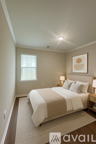 A bedroom with a large bed and a window.