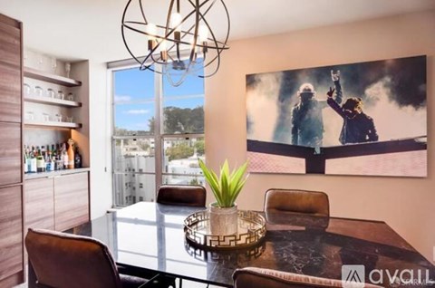 A modern dining room with a large poster on the wall.