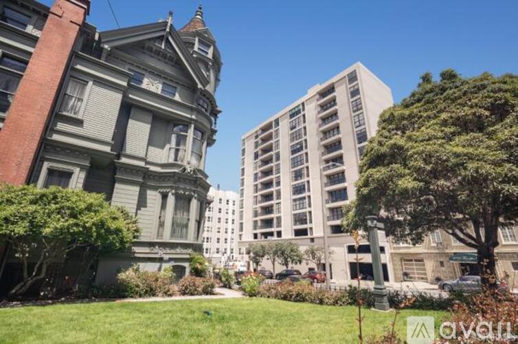 A large, old building sits next to a modern apartment building.