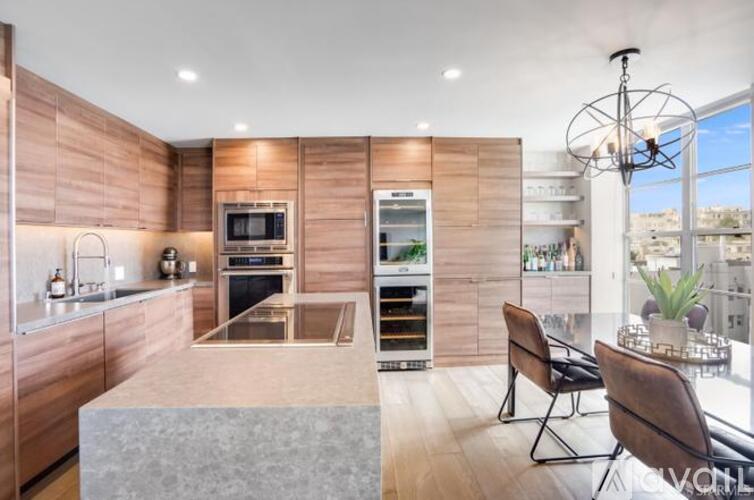 A modern kitchen with wooden cabinets and a marble countertop.