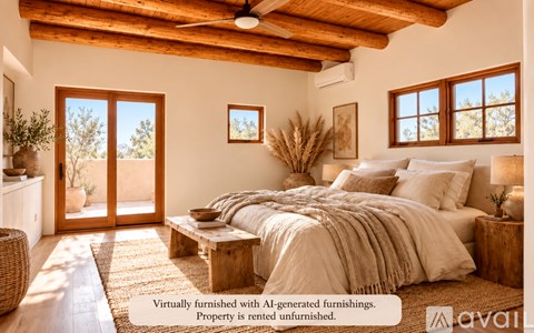 A bedroom with a bed, a bench, and a window.