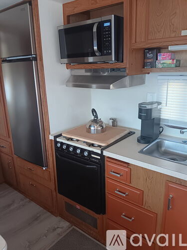 A kitchen with wooden cabinets and a black stove top.