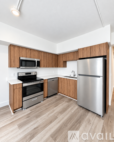 A kitchen with wooden cabinets and stainless steel appliances.