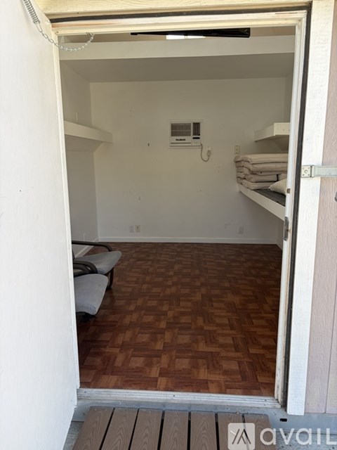 A small room with a bed and a chair.