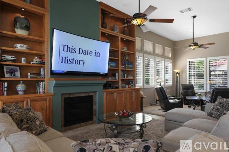 A living room with a television screen that says "This Date in History".